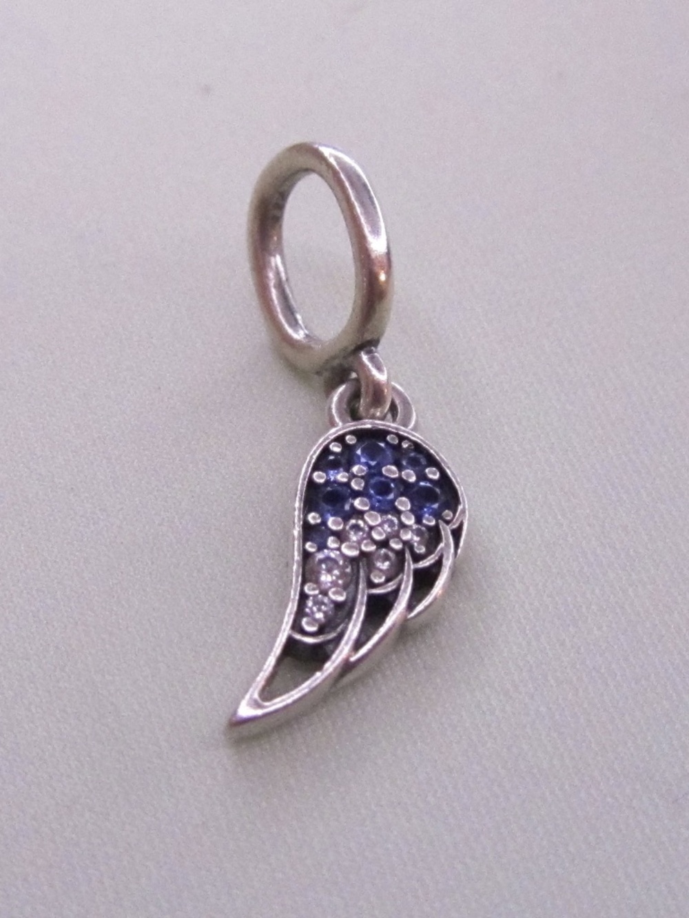 One half of Pandora Sparkling Splittable Angel Wings Dangle Charm